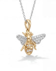 Gold bee pendant necklace with diamond accents on a white background