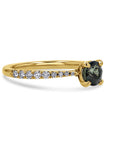 Gold ring with a black gemstone and small diamonds on a white background side