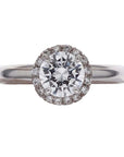 18k white gold halo engagement ring on a white background