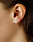 Close-up of an ear wearing a silver twisted stud earring.