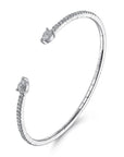 A white gold open cuff bangle bracelet with pavé-set clear stones along the outer curve and pear shaped stones at both ends, shown on a clean white background.