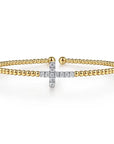 Gold bracelet with a diamond-cross design on a white background