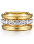 Gold ring with diamond-studded band on a white background