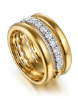 gold ring with diamond accents on a white background angled