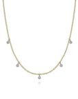 Gold necklace with small diamond droplets on a white background