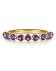 A yellow gold ring featuring nine round-cut purple amethyst gemstones, shown on a clean white background. The brand name 'GABRIEL & CO.
