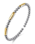 Bracelet with silver beads and gold accents on a white background