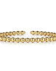 gold beaded bracelet on a white background