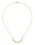 A delicate gold chain necklace with a small curved row of clear round drop gemstones at the center, displayed on a clean white background.