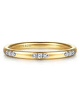 Gold ring with diamonds on a white background