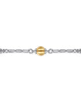 Gold and silver beaded bracelet on a white background close up
