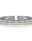 Silver and gold bracelet on a white background