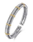 Silver and gold bracelet on a white background angled