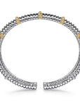 Silver and gold bracelet on a white background side view