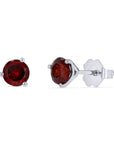 A pair of genuine round deep-red garnet stud earrings set in 14k white gold 3-prong mountings, showcasing one front view and one side profile view with a friction back on a solid white background.