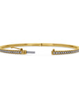 Gold bracelet with diamond accents with open clasp on a white background