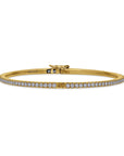 Gold bracelet with diamonds on a white background