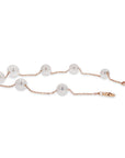 Pearl bracelet with rose gold chain on a white background
