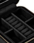 Black zippered jewelry organizer case with interior roll compartments and gold-tone zipper, shown open on a white background.