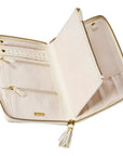 An open cream-colored zip-around case with gold-tone zippers, interior card slots, and a tassel zipper pull, shown on a plain white background.