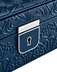 Blue jewelry box with floral embossing and a visible brand logo. close up
