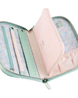 Open pastel-colored jewelry bag with floral lining on a white background