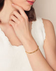 Woman wearing a gold bracelet on a neutral background Roberto Coin Love in Verona Diamond Station Bangle