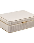 Rectangular jewelry case with ribbed texture and gold trim on a white background