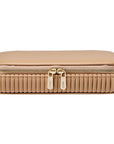 Beige travel case closed with gold zipper front view on a white background