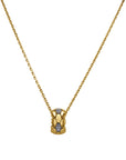 Gold necklace with a small pendant on a white background