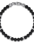 Black beaded bracelet with silver accents on a white background