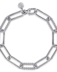 A silver-tone chain link bracelet featuring alternating large paperclip links and smaller beaded links, with a spring-ring clasp and a small circular logo charm.