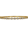 Gold bracelet with mixed shape diamonds on a white background