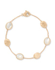 gold bracelet with mother of pearl stones on a white background