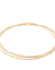 gold three strand necklace on white background