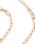A close-up of a gold paperclip chain necklace on a clean white background.
