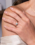 On model shot of a yellow gold solitaire engagement ring with a bezel set brilliant round diamond from Clarity Diamonds
