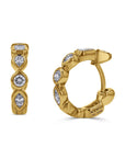 Gold hoop earrings with embedded diamonds on a white background angled