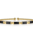 Gold and black enamel bracelet on a white background