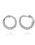 A pair of Gabriel & Co. 14k white gold bypass hoop earrings (Reference EG15558W45JJ) showcasing a fluid, overlapping ribbon design set with a shimmering rows of small round brilliant diamonds, displayed against a clean white background