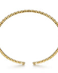 Gold beaded bracelet on a white background side view