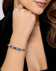 Close-up of a woman's arm wearing a blue bracelet with gold accents.