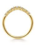 Gold ring with small diamonds on a white background- side shank view