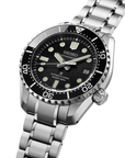 Seiko watch with black dial and silver metal bracelet on a white background angled