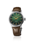 A Seiko wristwatch with a green textured dial, gold-tone hands and hour markers, and a brown leather strap, shown against a plain white background with a subtle reflection.