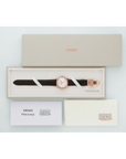 Seiko Presage watch with brown strap in a box on a light gray background