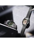 Two watches on a textured surface with a blurred background
