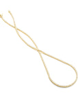Gold tennis necklace on a white background