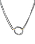 An artisanal Lika Behar "Orion" shield pendant necklace in hand-hammered 24K yellow gold and dark oxidized sterling silver, accented with 0.22 carats of pavé diamonds on an adjustable link chain.