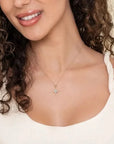 Close-up of a woman wearing a necklace with a star-shaped pendant.